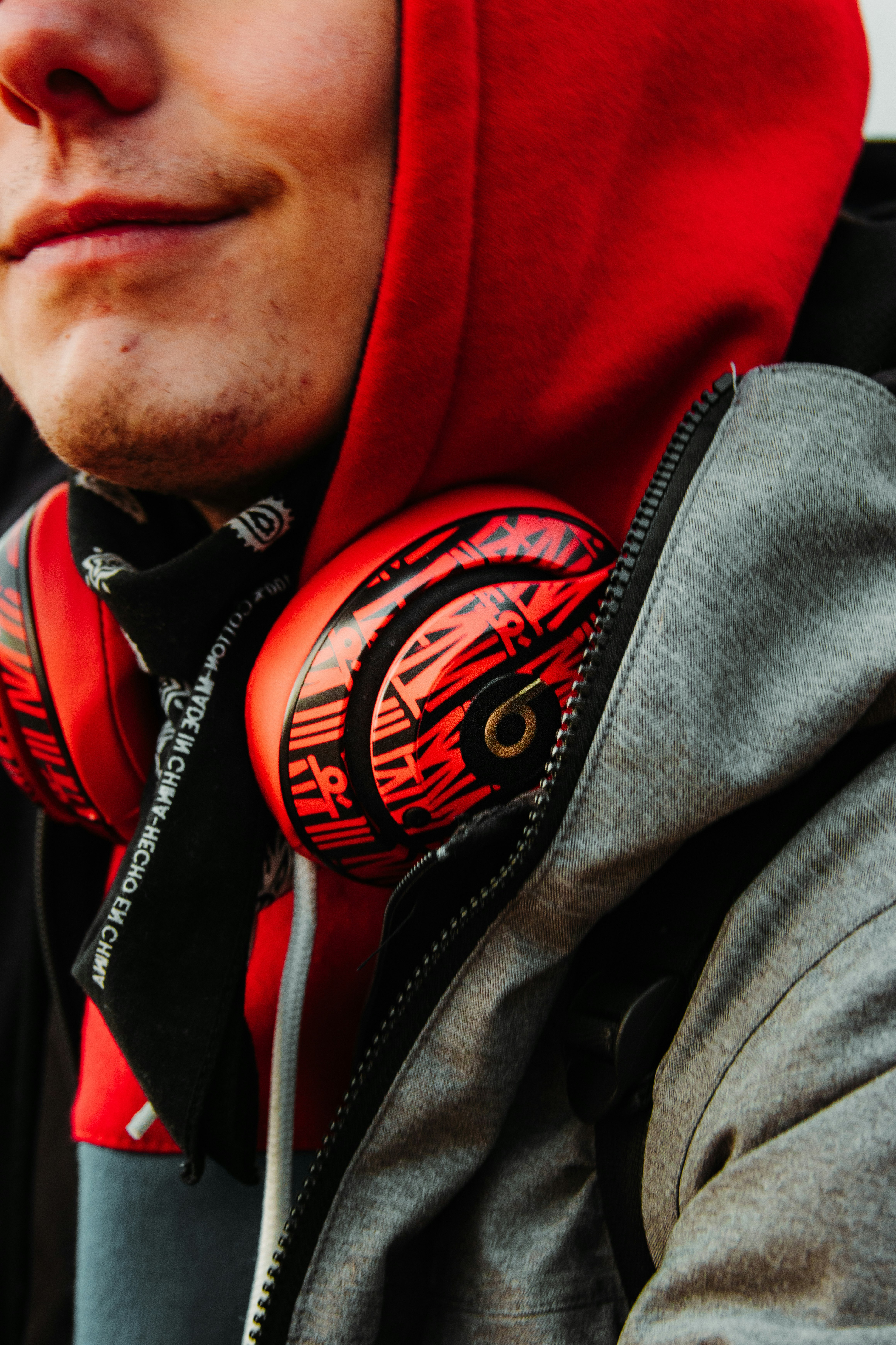 man in red hoodie wearing black and red sunglasses